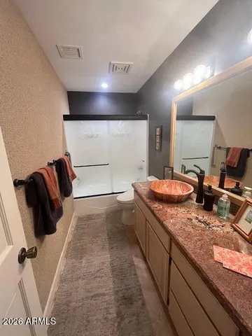 a bathroom with double vanity and a mirror