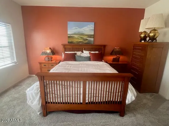 a bedroom with a bed and window