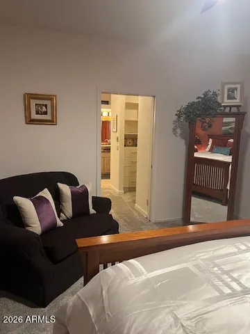 a living room with a couch and a dresser with wooden floor