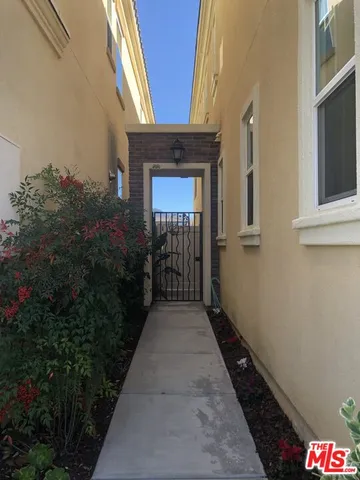a kitchen with stainless steel appliances kitchen island granite countertop a sink and a refrigerator