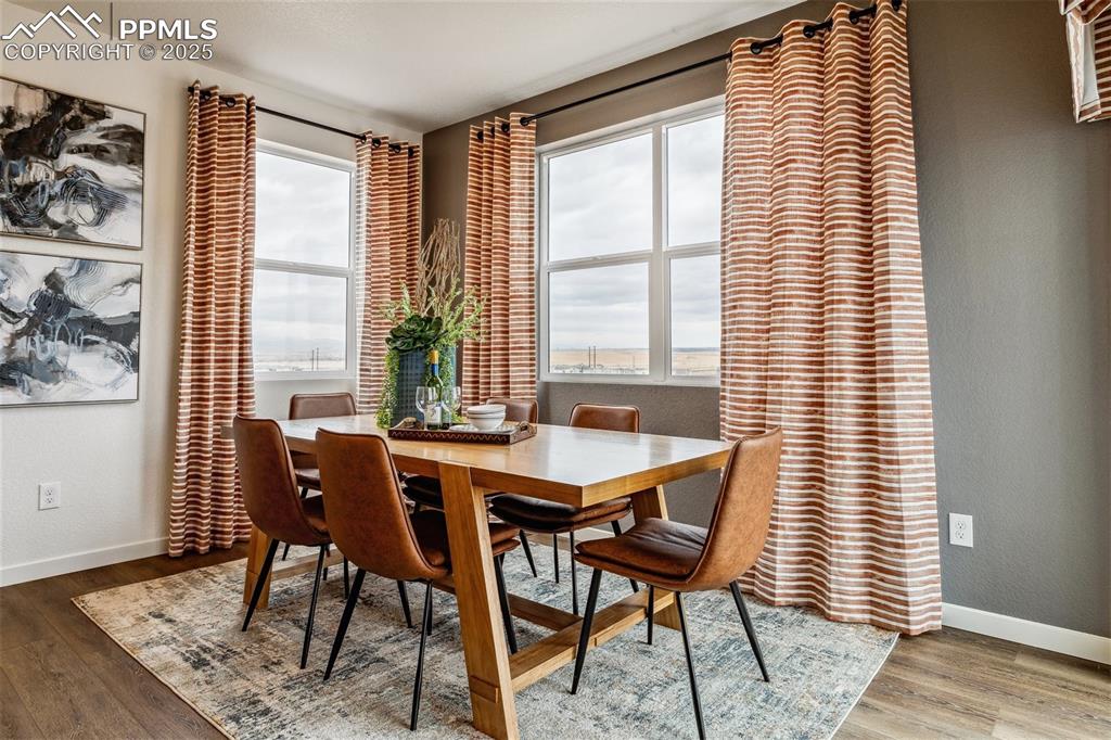 6146 Alpine Rdg Drive Colorado Springs, CO 80925 - Photo 11 of 22 a view of a dining room with furniture and wooden floor