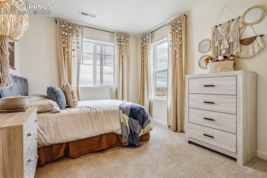 6146 Alpine Rdg Drive Colorado Springs, CO 80925 - Photo 12 of 22 a spacious bedroom with a bed and a window