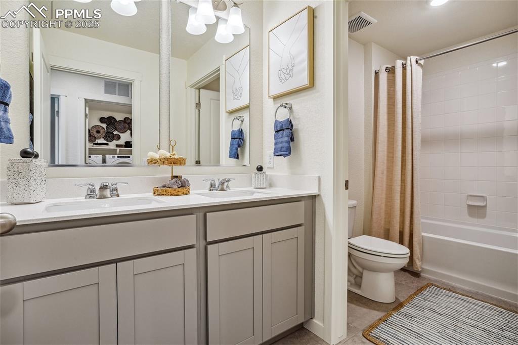 6146 Alpine Rdg Drive Colorado Springs, CO 80925 - Photo 14 of 22 a bathroom with a sink a toilet a mirror and shower