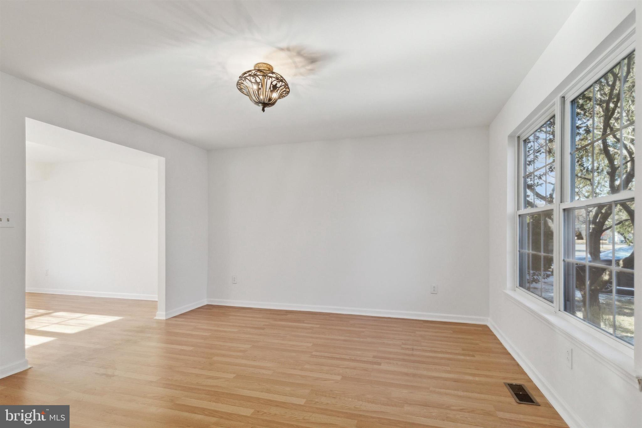 4420 Kelly Lane Reading, PA 19606 - Photo 4 of 25 a view of an empty room with a window and wooden floor