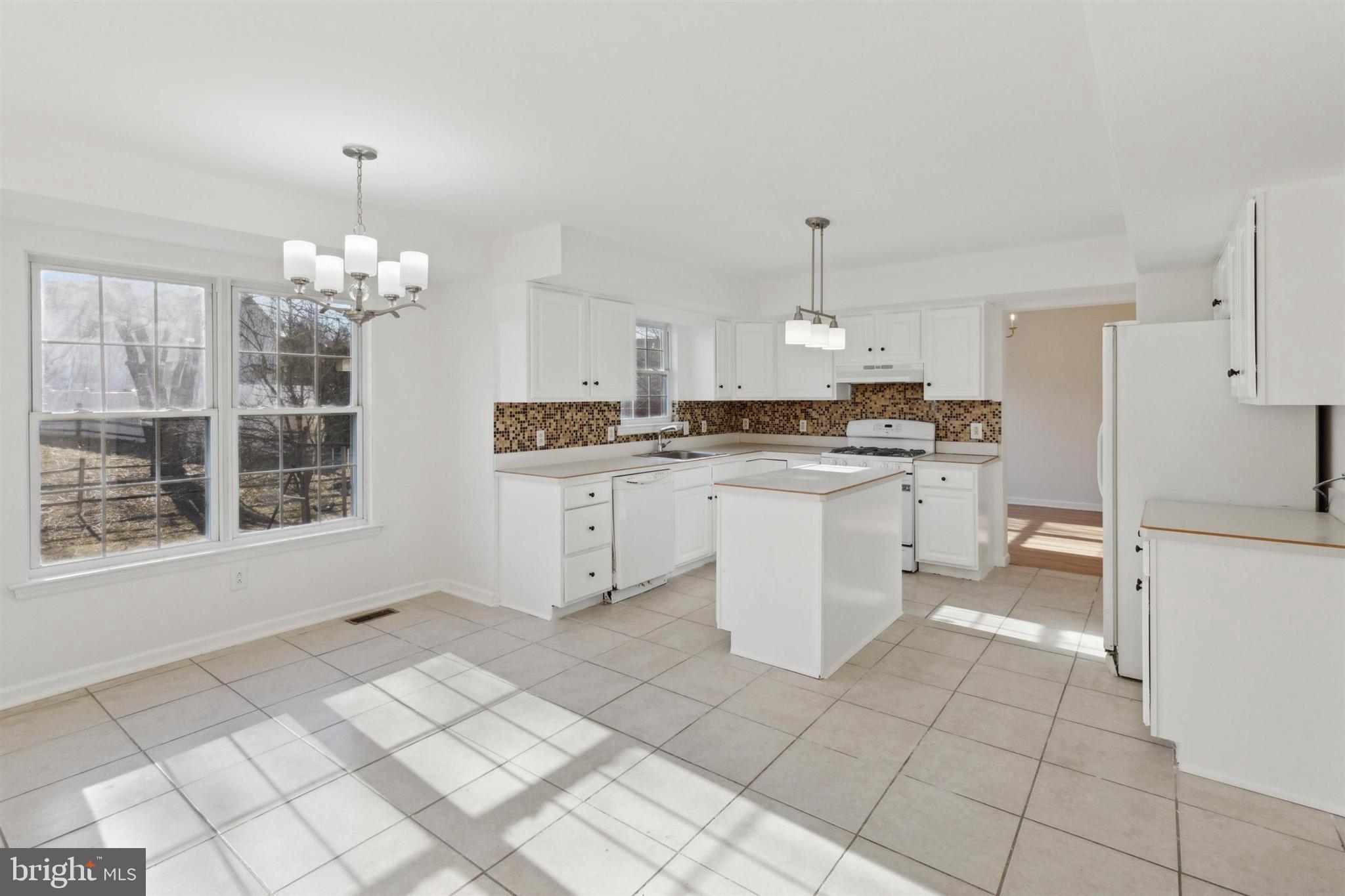 4420 Kelly Lane Reading, PA 19606 - Photo 7 of 25 a kitchen with a stove a sink and a refrigerator