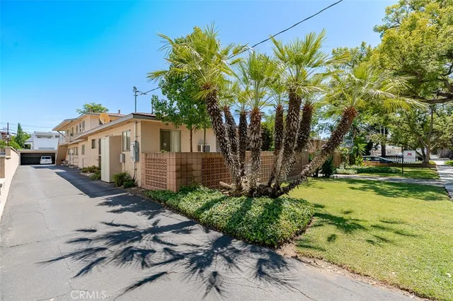 an aerial view of residential houses with outdoor space and street view