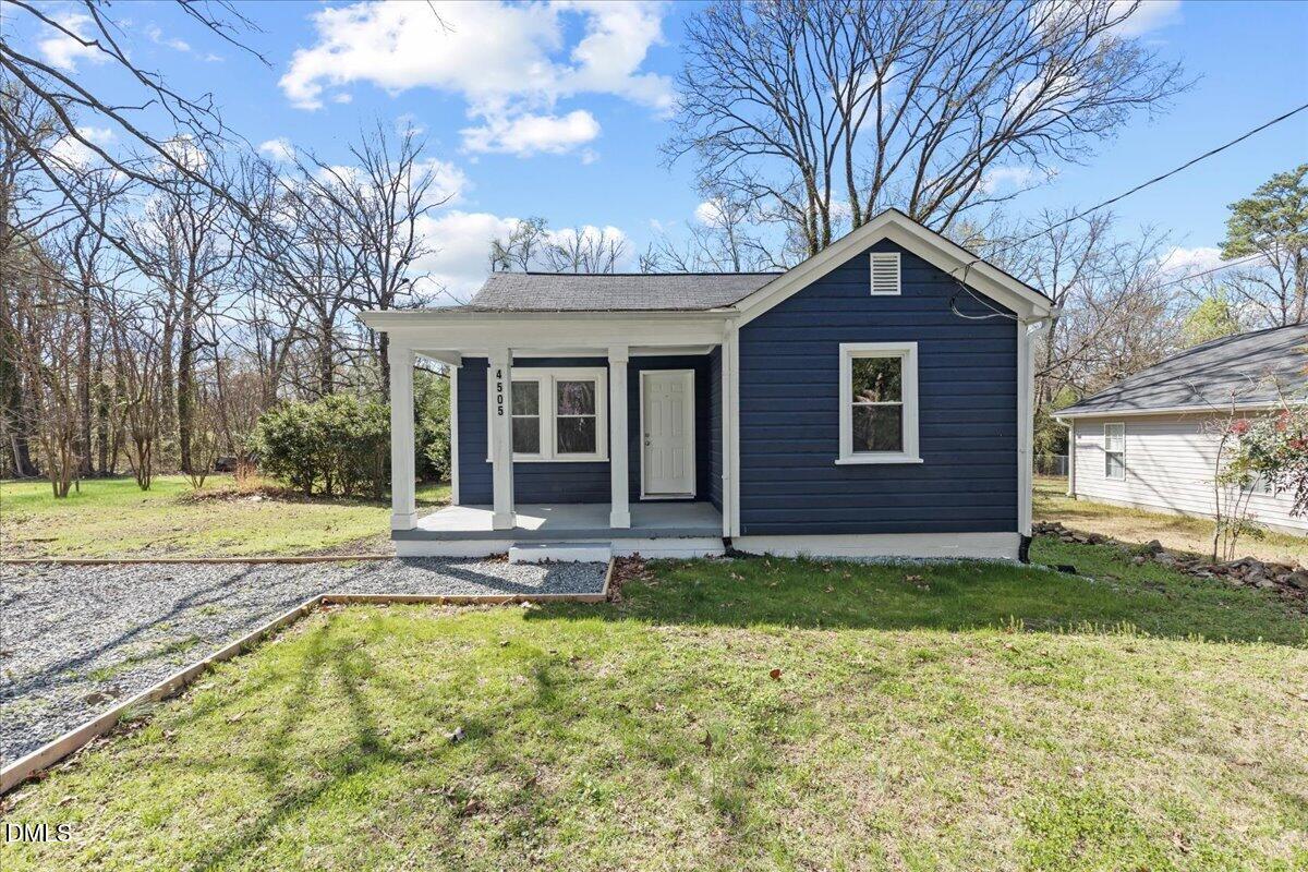 a view of a house with a yard patio and fire pit