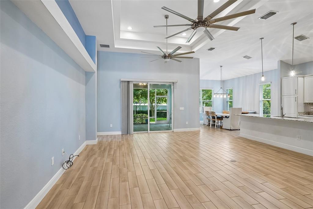 10339 Addison Shore Way Oxford, FL 34484 - Photo 26 of 54 a view of a livingroom with a flat screen tv and a ceiling fan