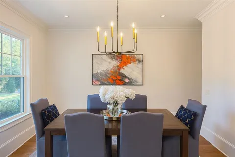 a dining room with furniture and wooden floor