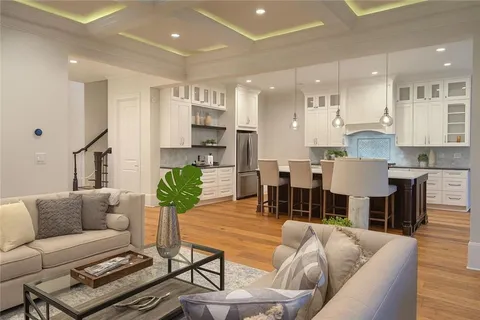 a living room with furniture kitchen and a table