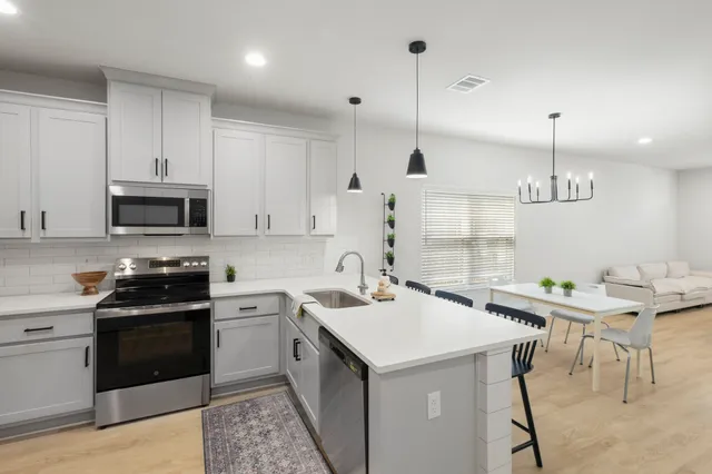 a kitchen with sink cabinets and stainless steel appliances