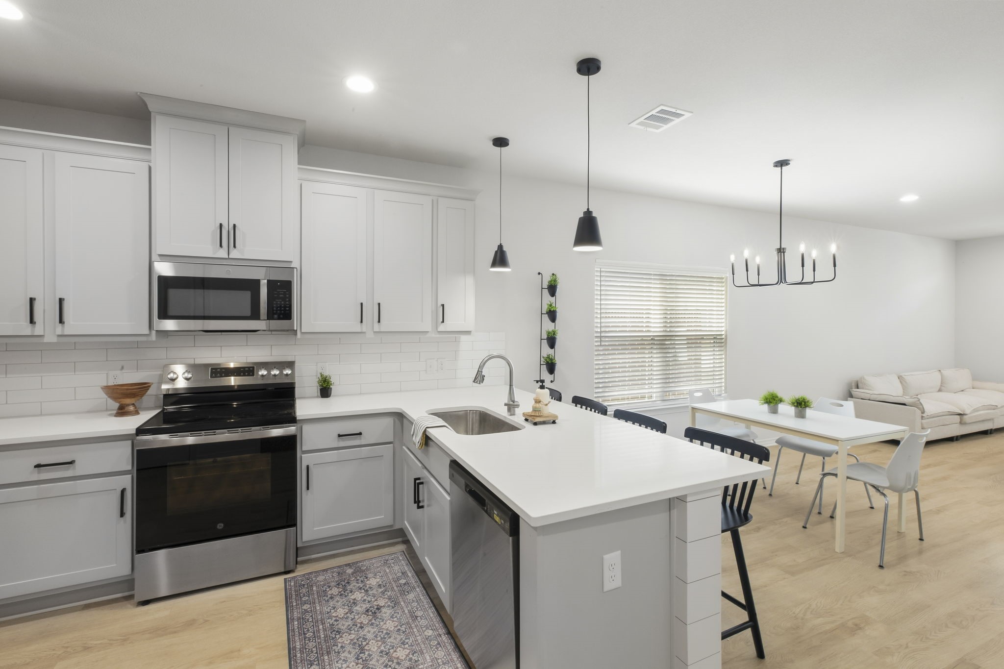 228 Richards Street College Station, TX 77840 - Photo 16 of 43 a kitchen with a sink a stove and chairs