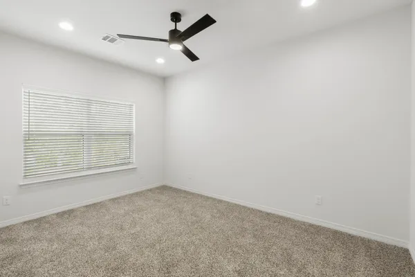 a bedroom with a bed and a potted plant