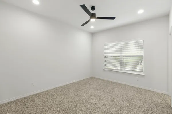 a bedroom with a large bed and a large window