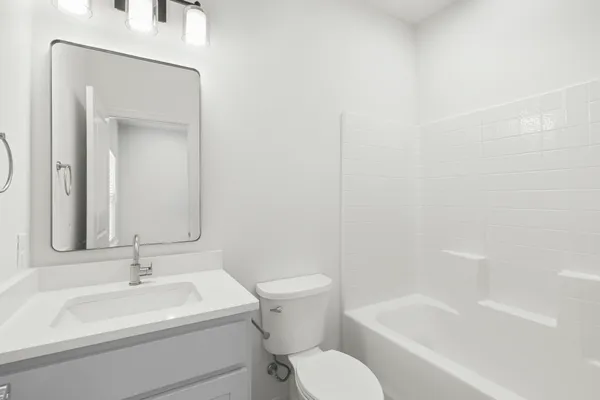 an empty room with ceiling fan and window