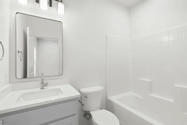 an empty room with ceiling fan and window