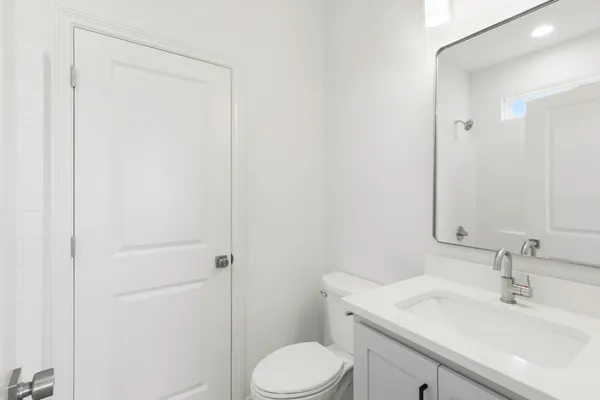 an empty room with windows and ceiling fan