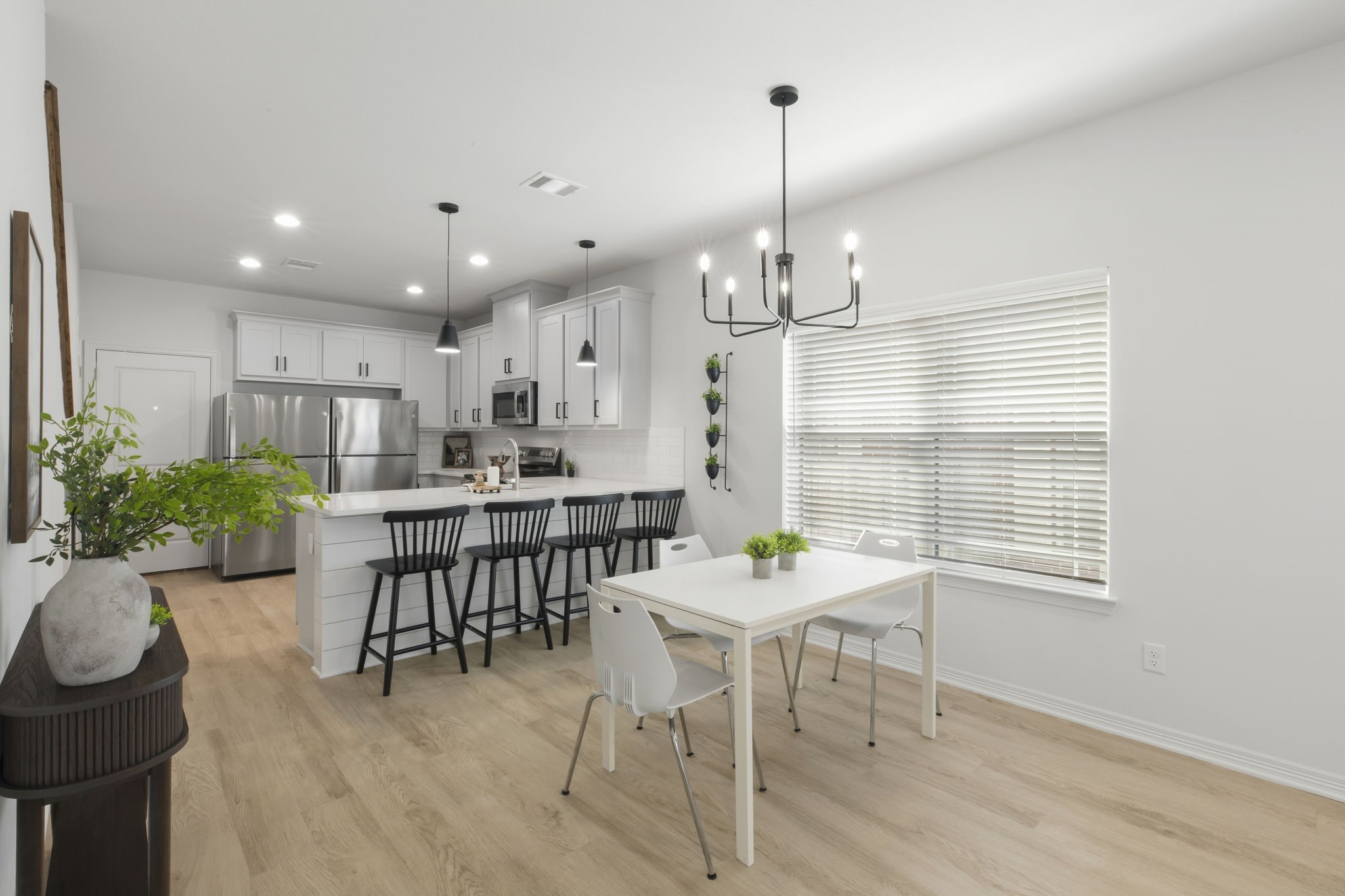 228 Richards Street College Station, TX 77840 - Photo 4 of 43 a view of a dining room and livingroom with furniture wooden floor a chandelier