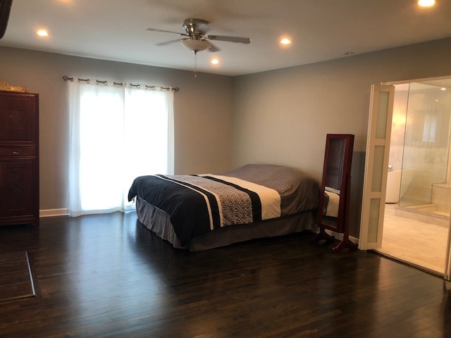 14935 West Old School Road Mettawa, IL 60048 - Photo 18 of 65 a bedroom with a bed a window and wooden floor