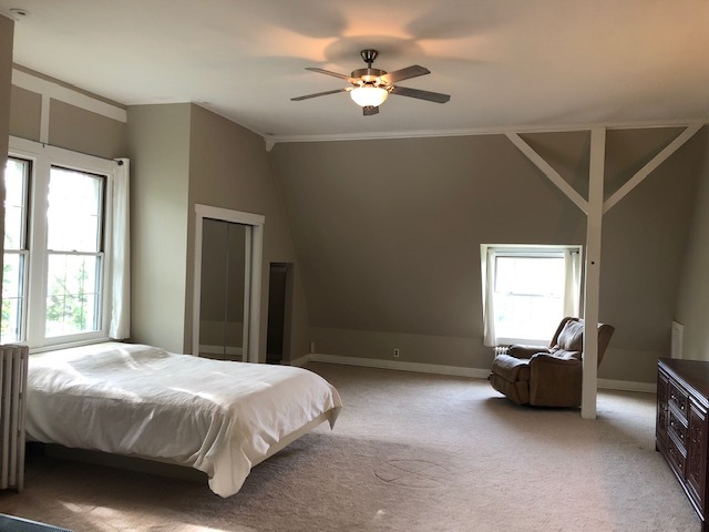 14935 West Old School Road Mettawa, IL 60048 - Photo 25 of 65 a spacious bedroom with a bed and a chandelier