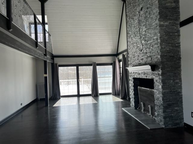 14935 West Old School Road Mettawa, IL 60048 - Photo 29 of 65 a view of an empty room with wooden floor fireplace and a window