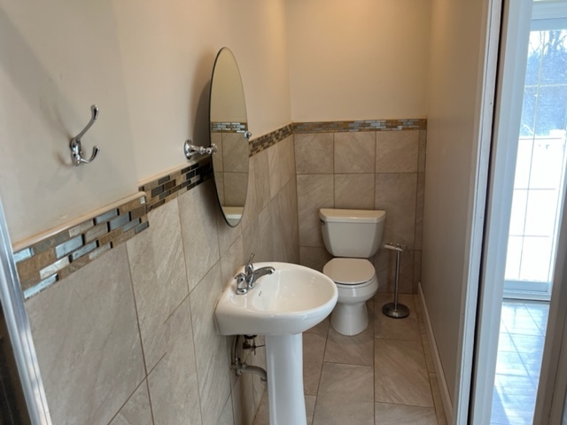 14935 West Old School Road Mettawa, IL 60048 - Photo 35 of 65 a bathroom with a sink toilet and a mirror