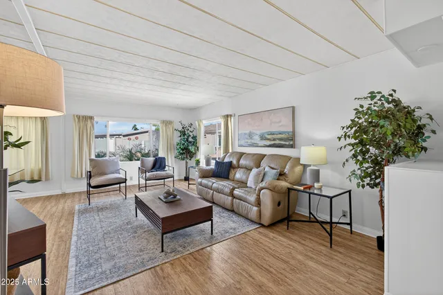 a living room with furniture and wooden floor