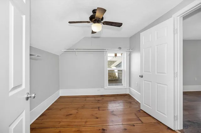 a view of empty room with wooden floor