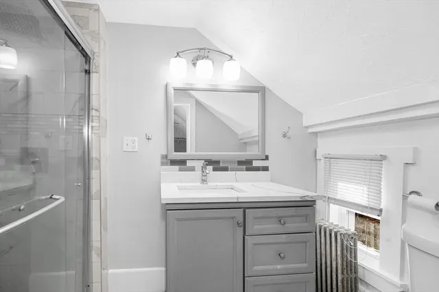 a bathroom with a sink vanity and a mirror