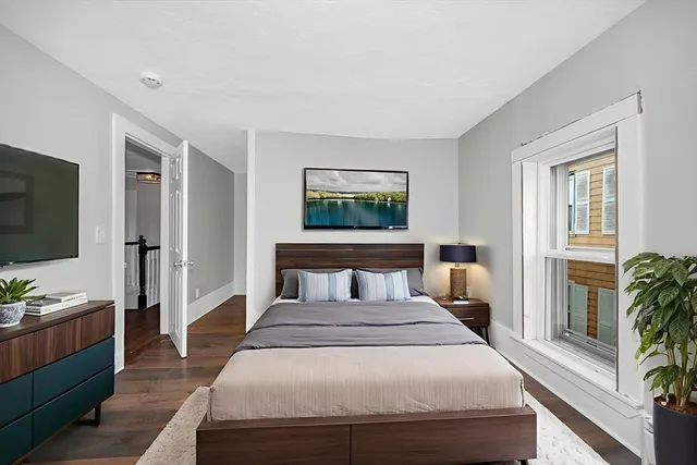 a bedroom with a large bed and a flat screen tv