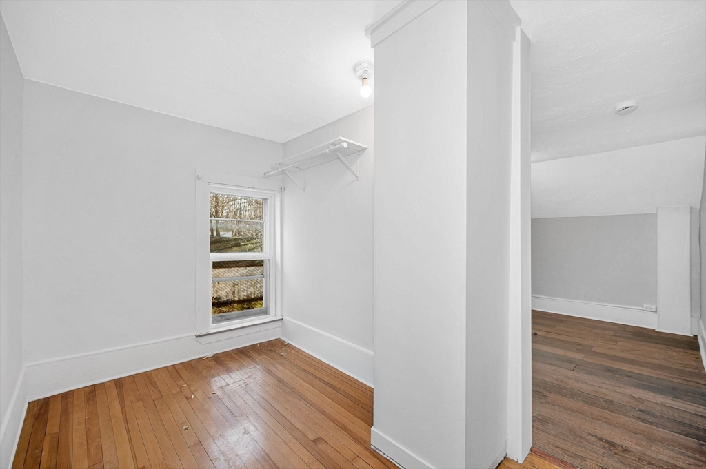 197 High Street Holden, MA 01522 - Photo 22 of 33 an empty room with wooden floor closet and windows