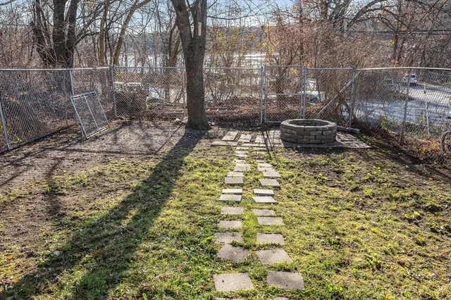 a backyard of a house with lots of green space and fountain