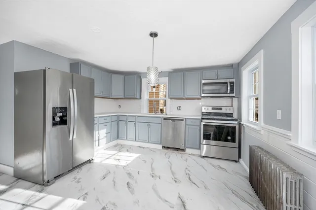 a kitchen with stainless steel appliances a refrigerator sink and stove