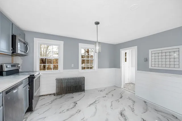 a view of a kitchen with a sink dishwasher and fireplace