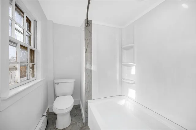 a white toilet sitting next to a bathroom sink