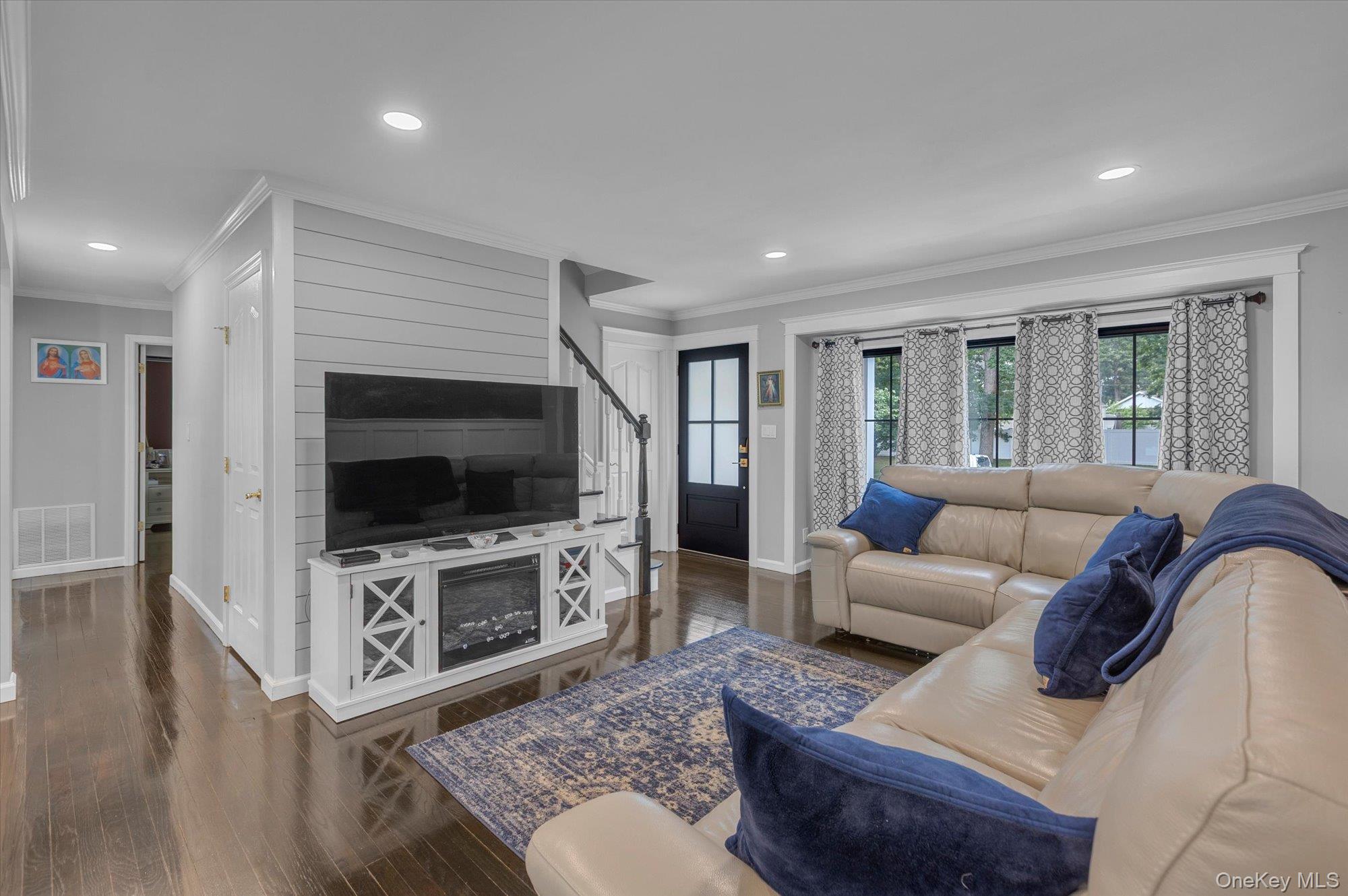 31 Apple Lane Commack, NY 11725 - Photo 2 of 28 Open concept. Direct access to dining area and kitchen. Feature wall with shiplap detail.