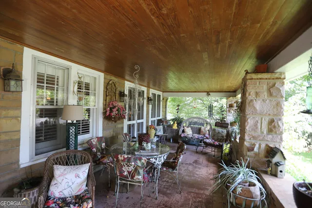 a view of house with a yard and potted plants