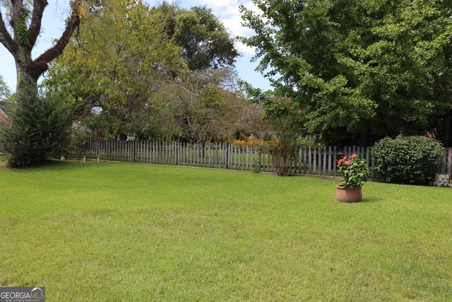 a view of a house with a yard and plants