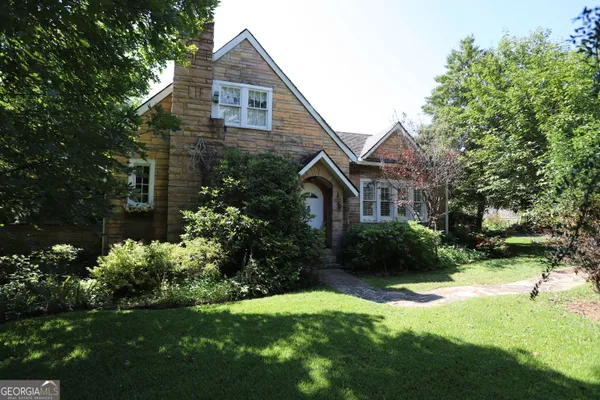 a front view of a house with garden