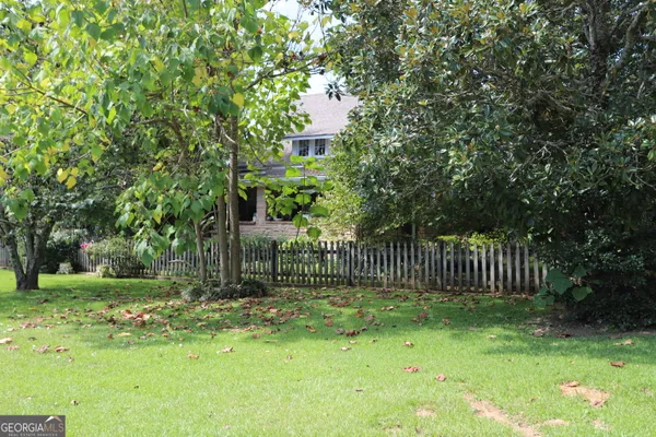 a view of a house with a yard and a garage
