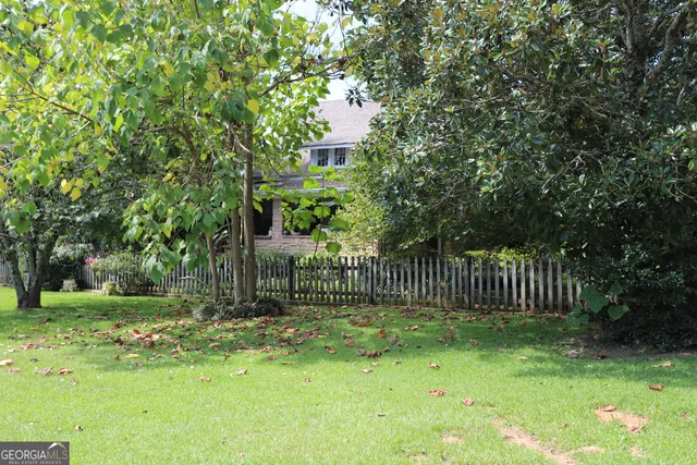 a view of a house with a yard and a garage