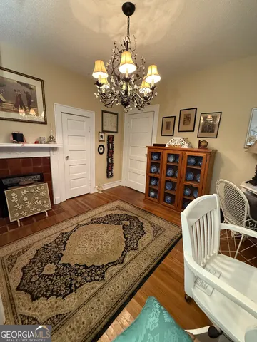 a living room with furniture a rug and a window