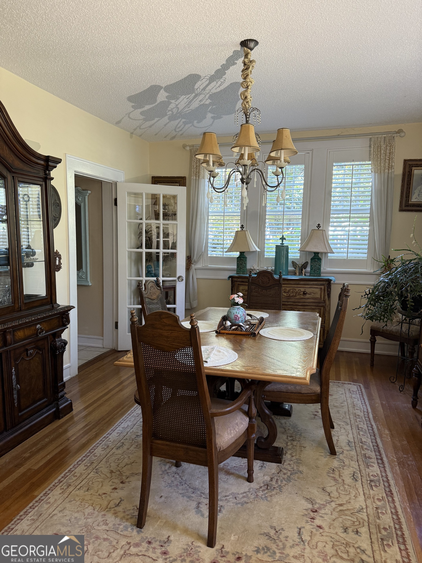 360 Edison Street Menlo, GA 30731 - Photo 40 of 64 a dining room with furniture a chandelier and wooden floor