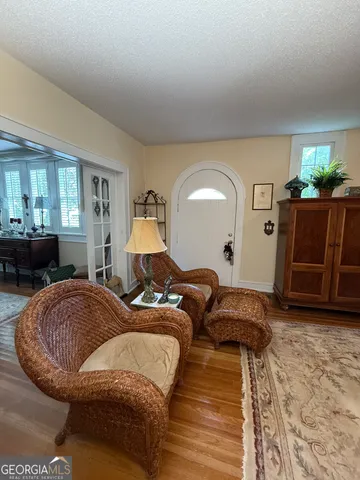 a spacious bedroom with a bed and wooden floor