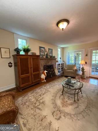 a living room with furniture and floor to ceiling windows