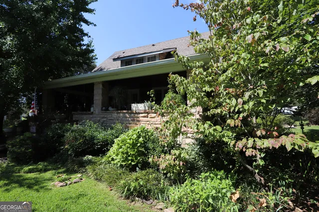a front view of a house with lots of green space