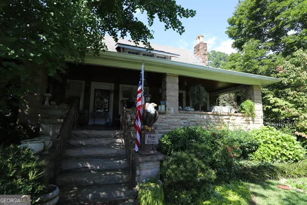 a view of a porch with dining table and chairs