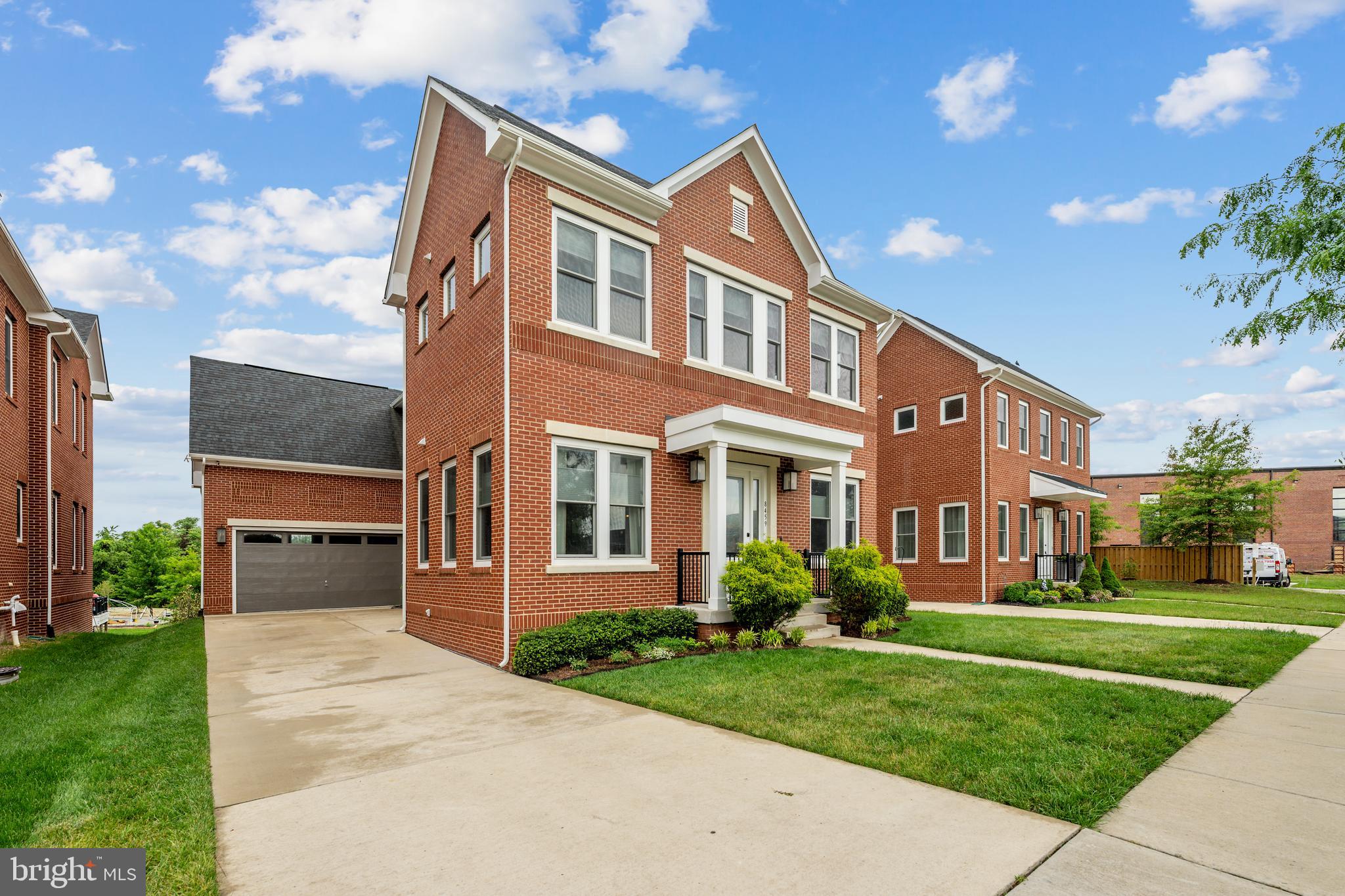 8459 Reformatory Way Lorton, VA 22079 - Photo 58 of 78 a front view of a house with a yard and garage
