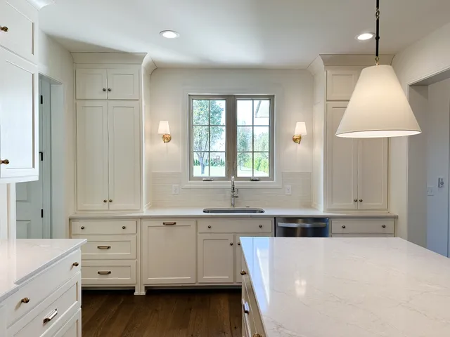a large white kitchen with a white cabinet and a stove