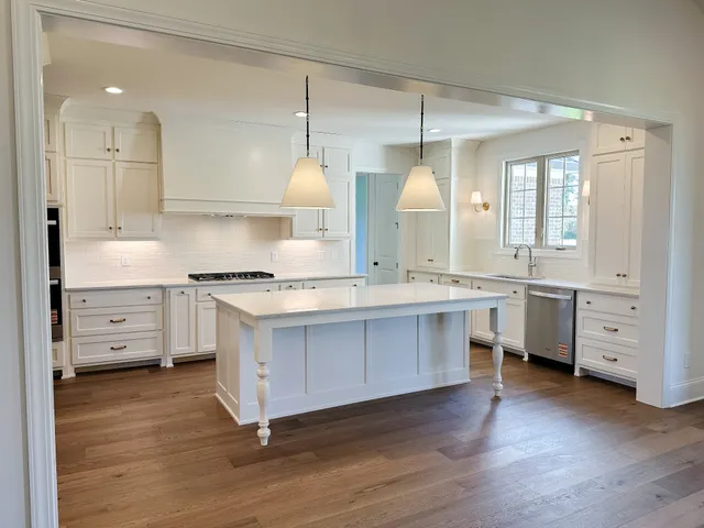 a spacious bathroom with a granite countertop sink a mirror and shower view